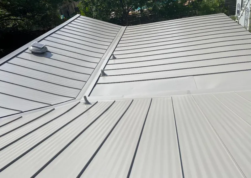 Solar attic fan installed on a metal roof for Roof Ventilation in Ontario